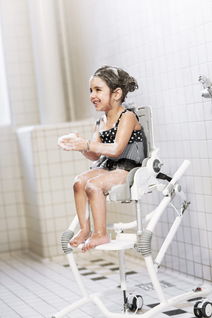 R82 Flamingo High-low -wc ja suihkutuoli - tyttö kylpyhuoneessa